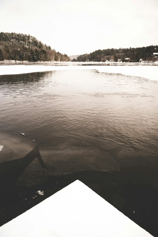 a black and white po of the lake with snow