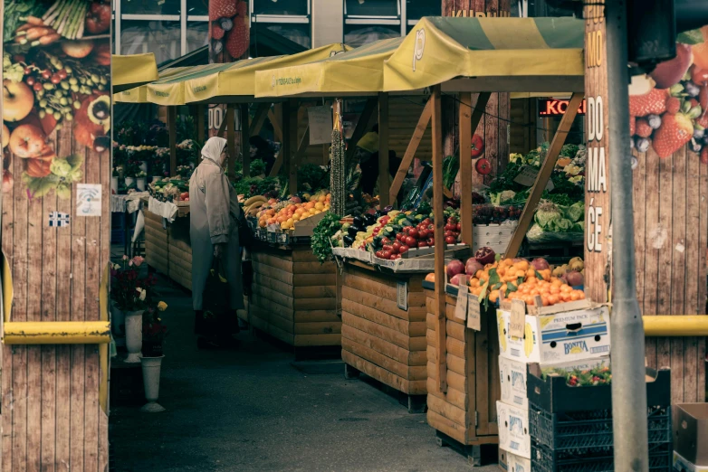 an outdoor stand is displaying fruits and vegetables