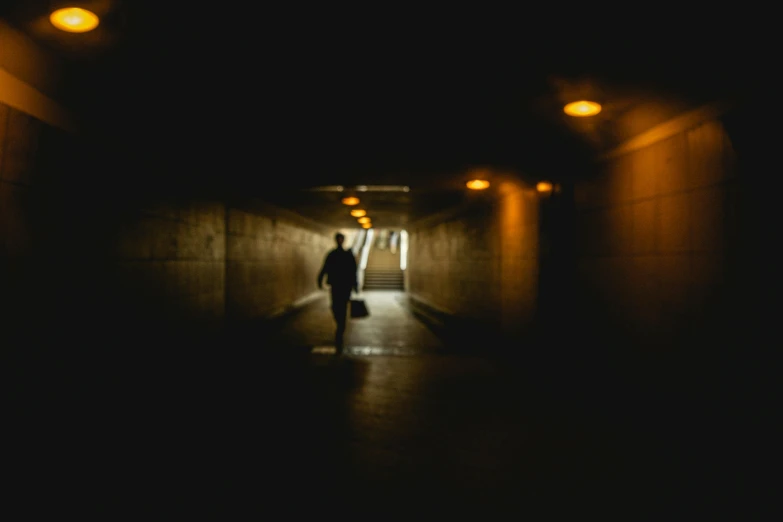 a person walking down a dark corridor at night