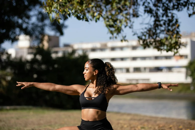 a woman wearing a black  - top in the park