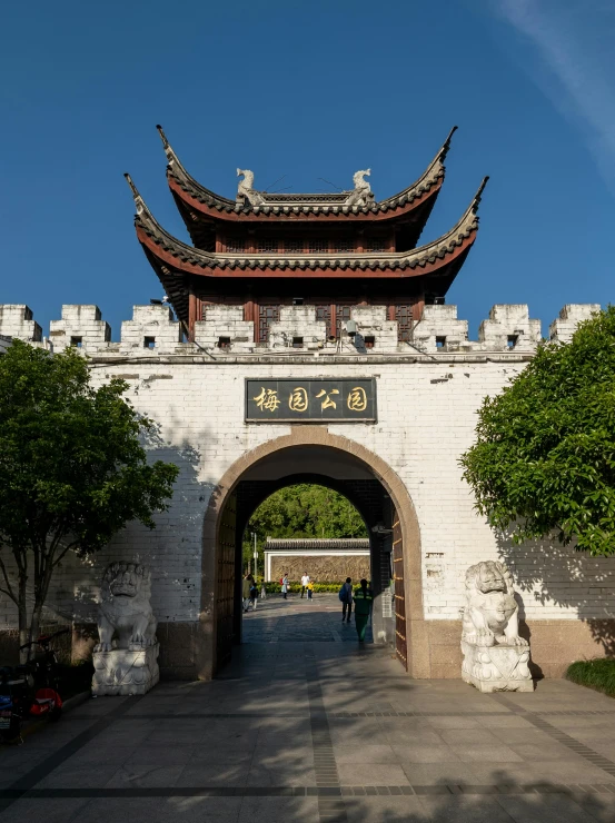 an archway leads to a palace with tall gates