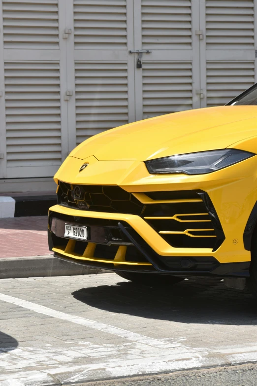 a yellow lamb sports car parked in the street