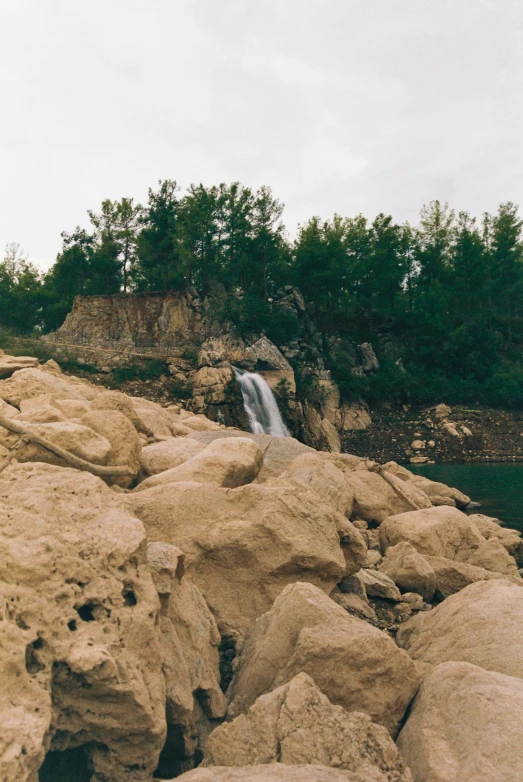 a small waterfall with some rocks on it