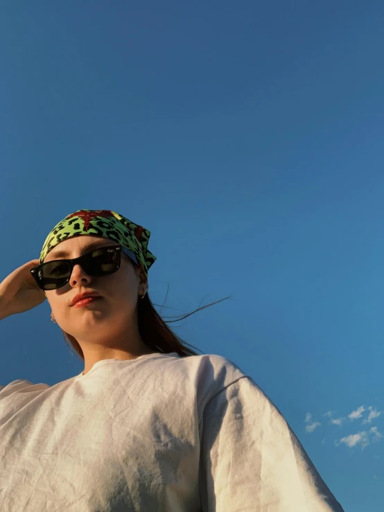 a woman wearing sunglasses and a bandana
