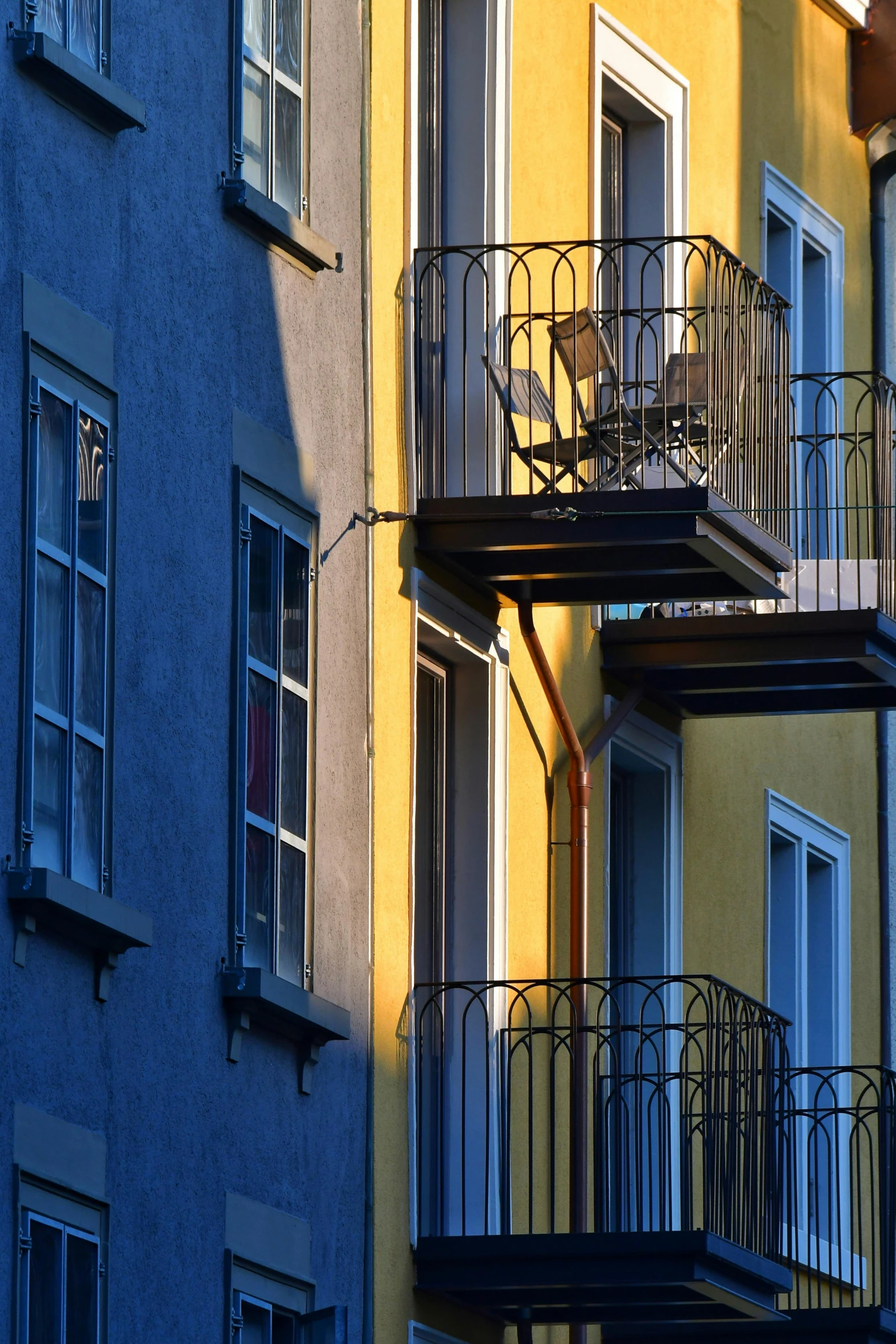 the shadows of several buildings are cast onto the ground