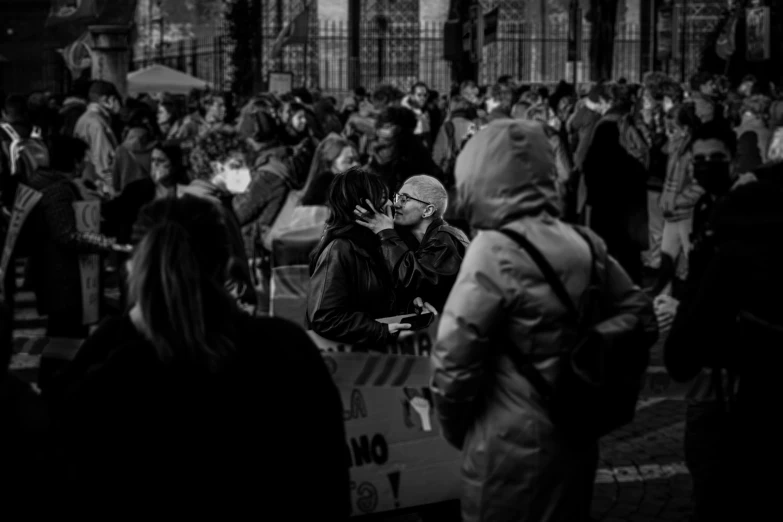 a crowd of people are standing together and talking