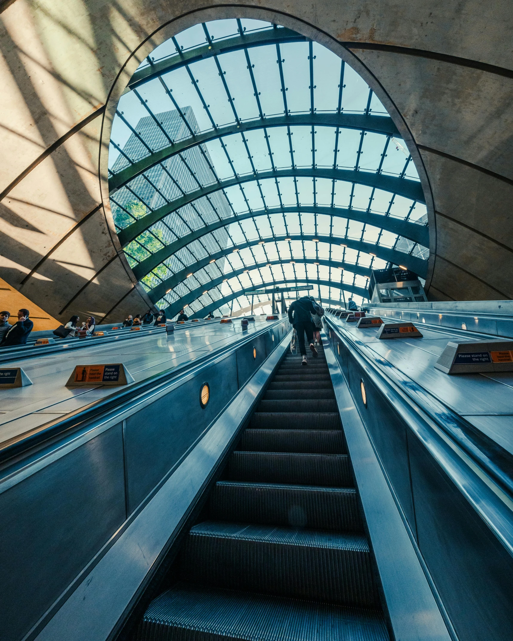 an escalator going up in the ceiling with people on it