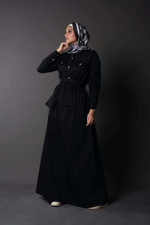 a woman wearing black clothing poses for the camera