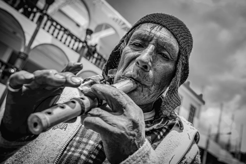 a woman playing a flute by some buildings