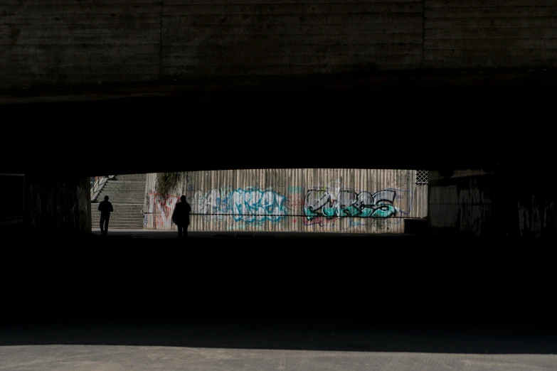 two men are looking at graffiti on the wall