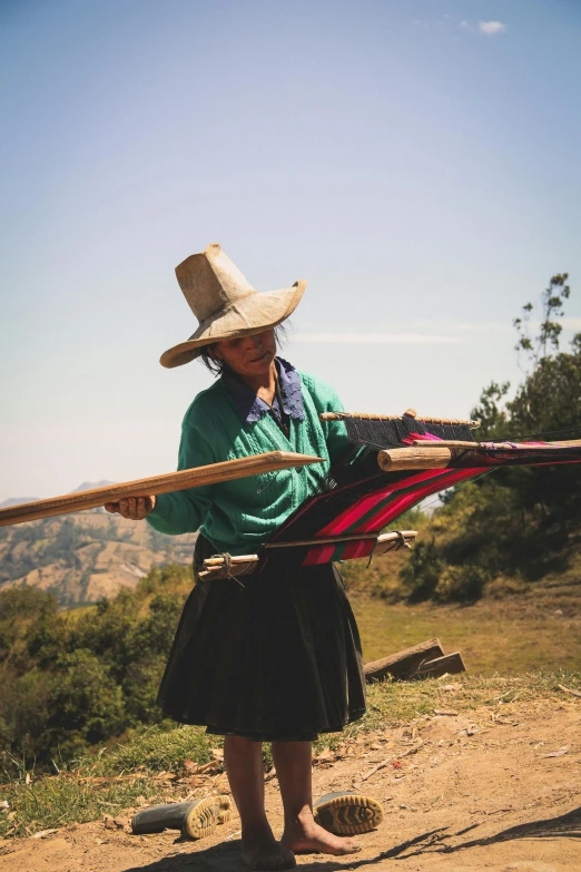 a woman is standing on a hill with some skis