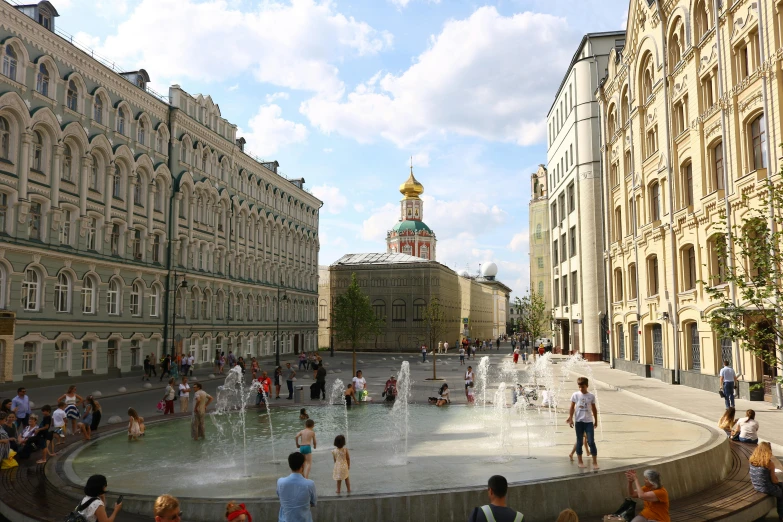 people gather around the water fountains at the park