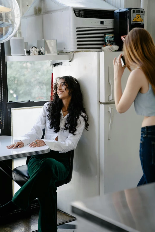 the woman is sitting in a chair smiling