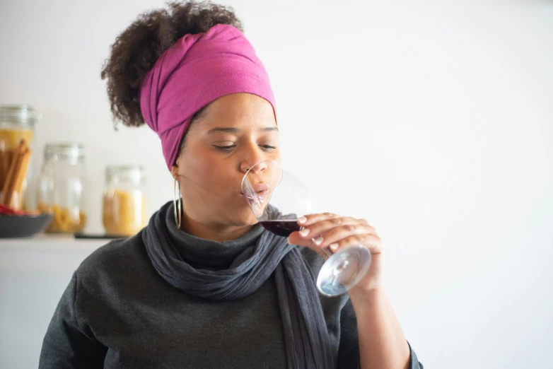 a person wearing a turban drinking from a glass