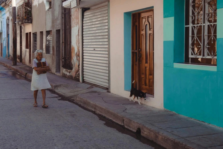 a person walks down a narrow city street