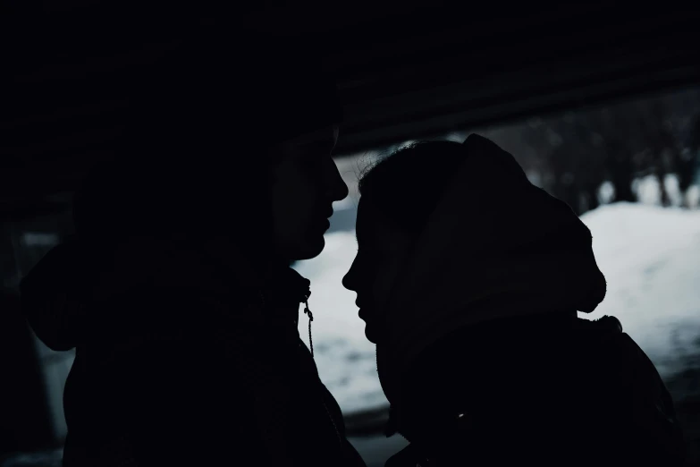 the silhouette of a man and woman facing each other