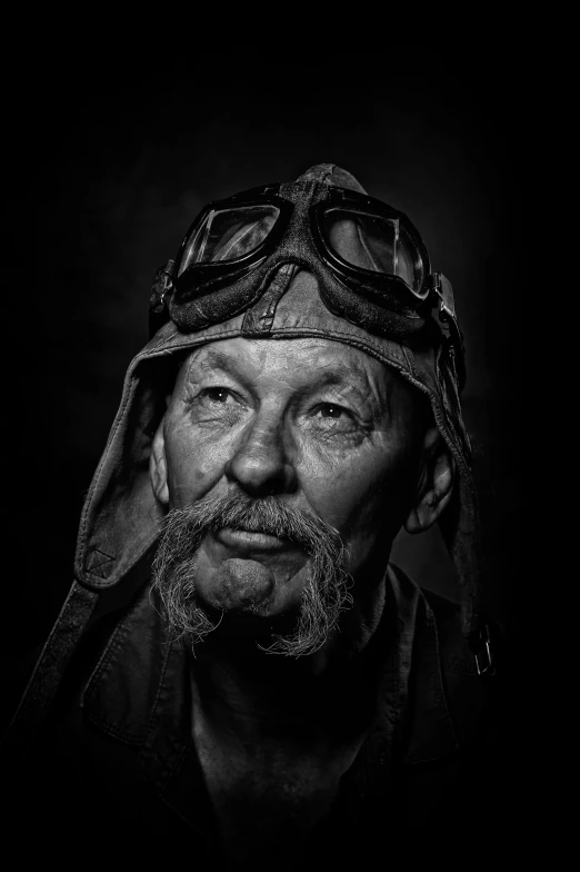 an older man wearing glasses and a helmet