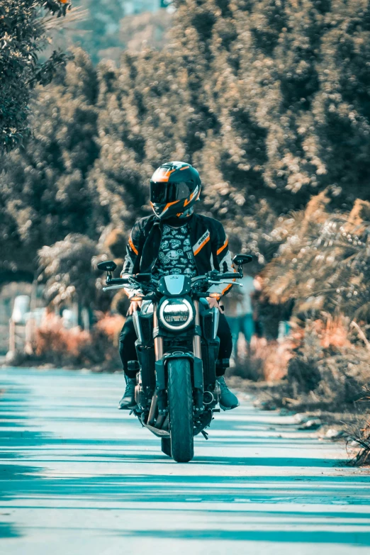 a man is riding a motorcycle down the road