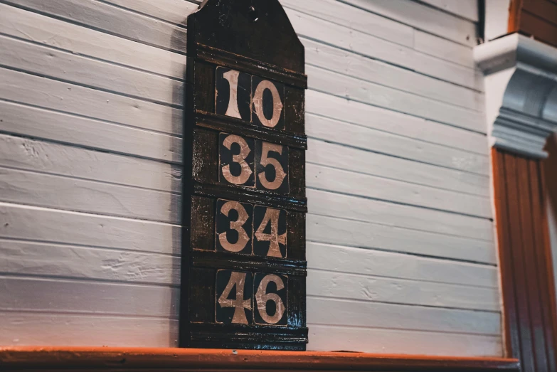 a sign is mounted on the wall next to some siding