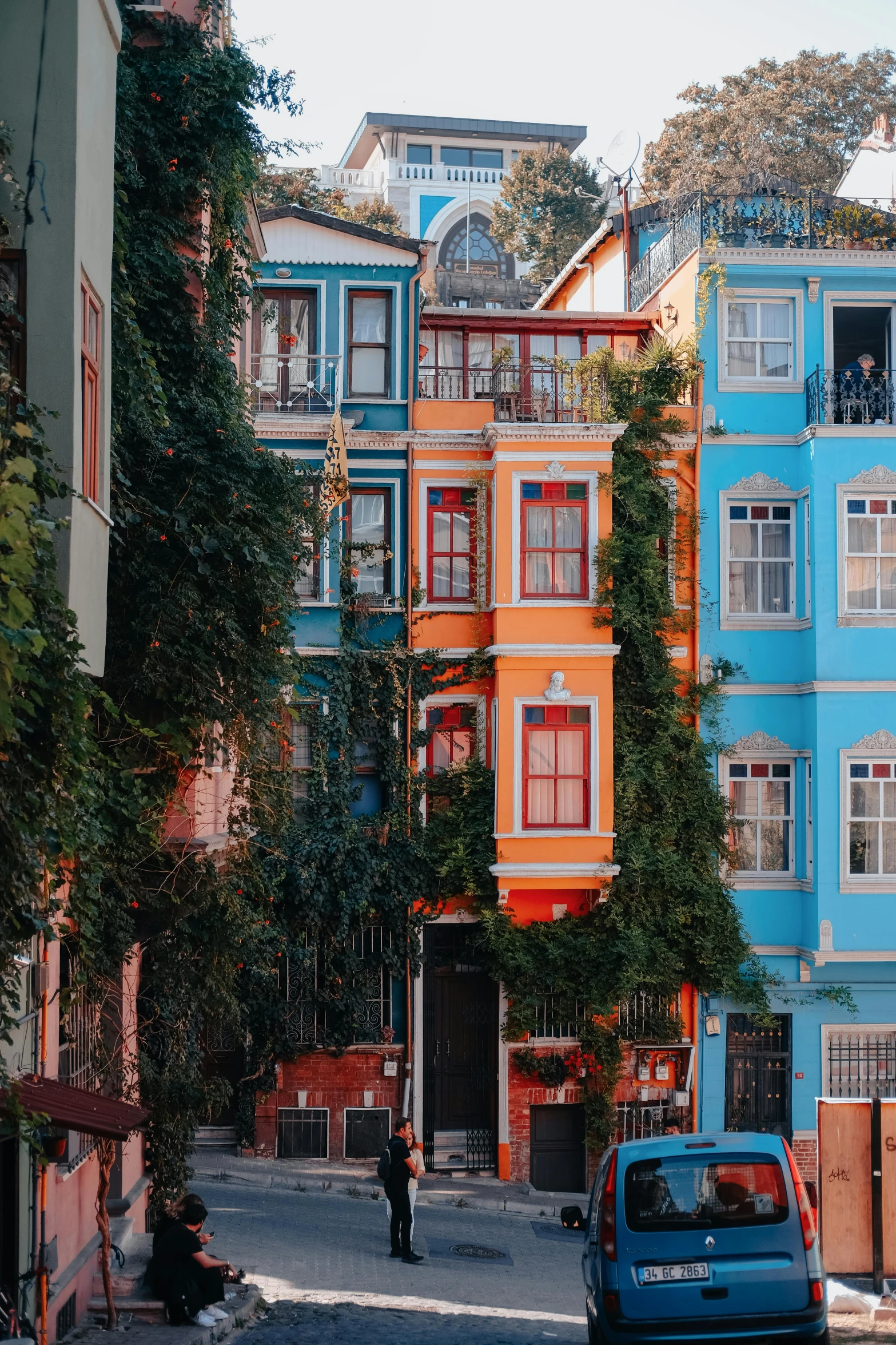 there are several blue and orange buildings along the street