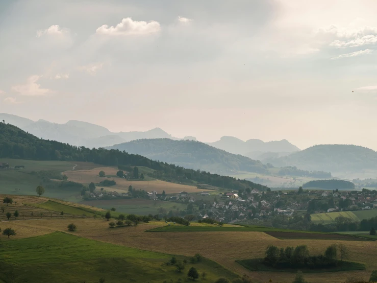 landscape of rolling hills and a small village on a distant hill