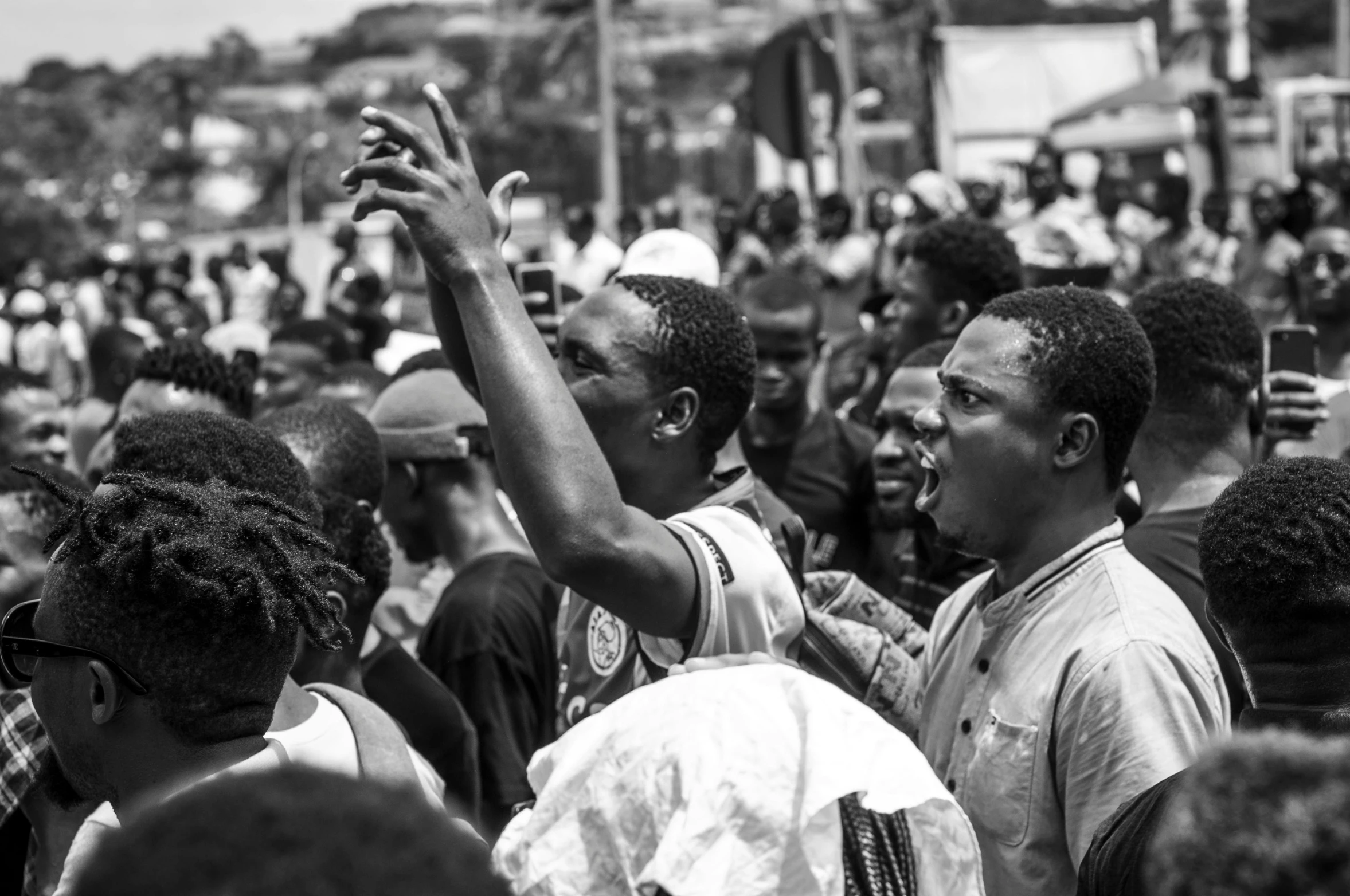 a black and white po of people holding hands in the air