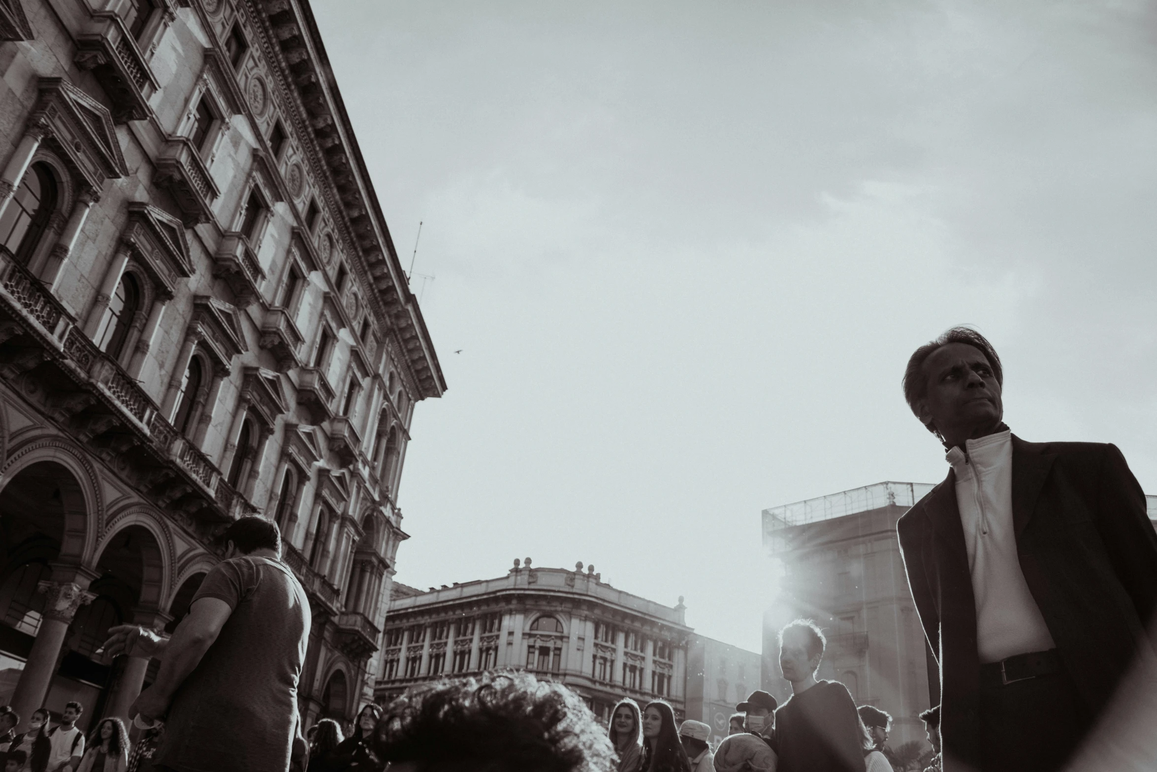 a crowd of people standing around a building