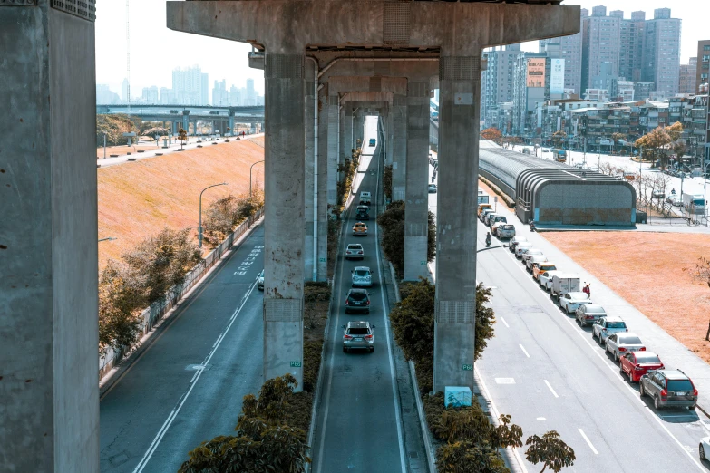 cars are driving on the highway near tall buildings