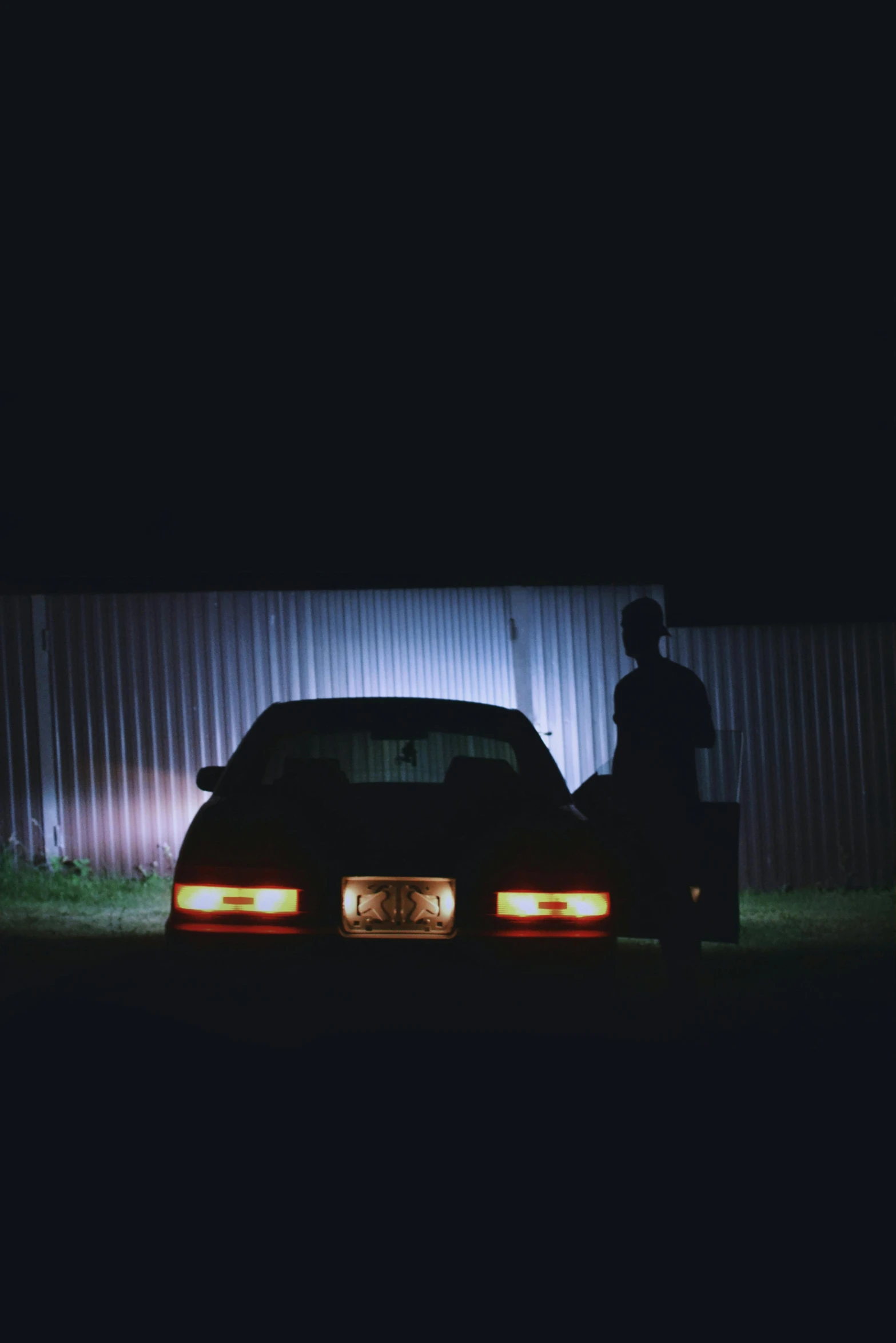 a man standing next to a car and a building