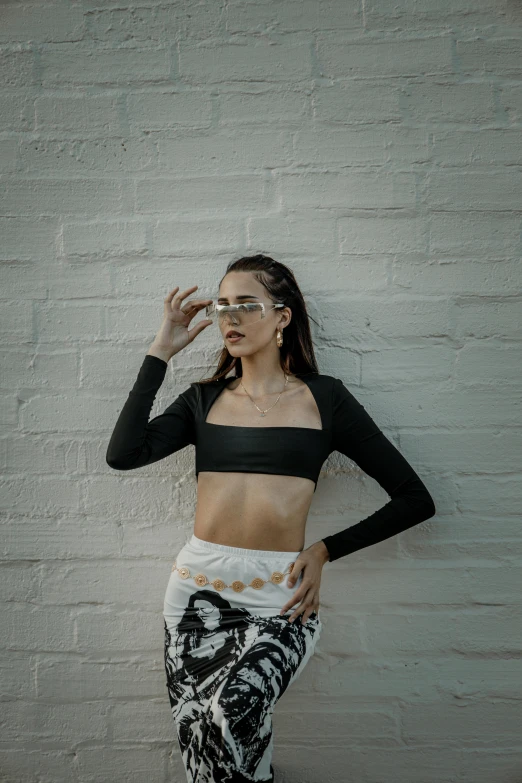 a woman standing with her hands on her temples