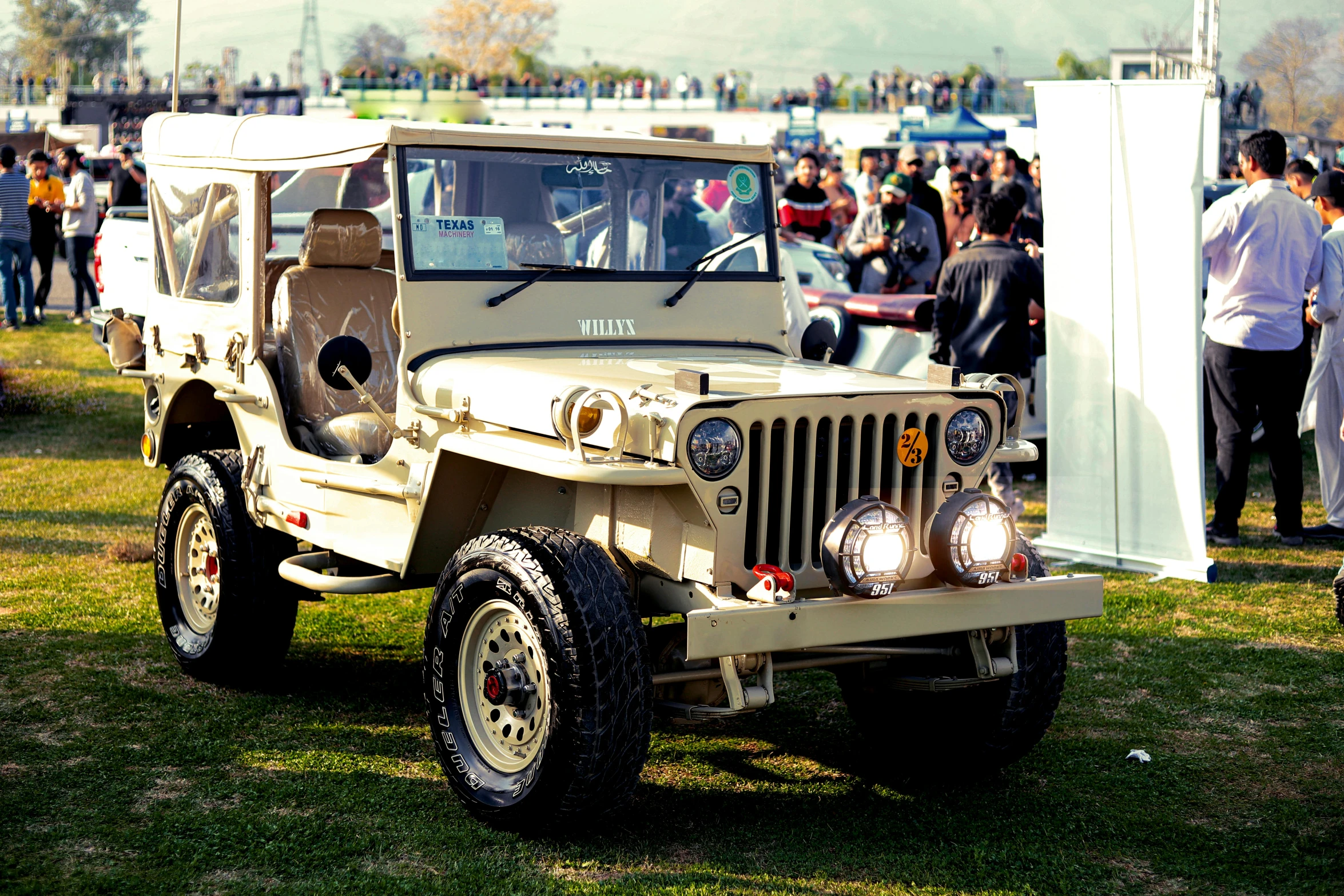 the military jeep is parked in the grass