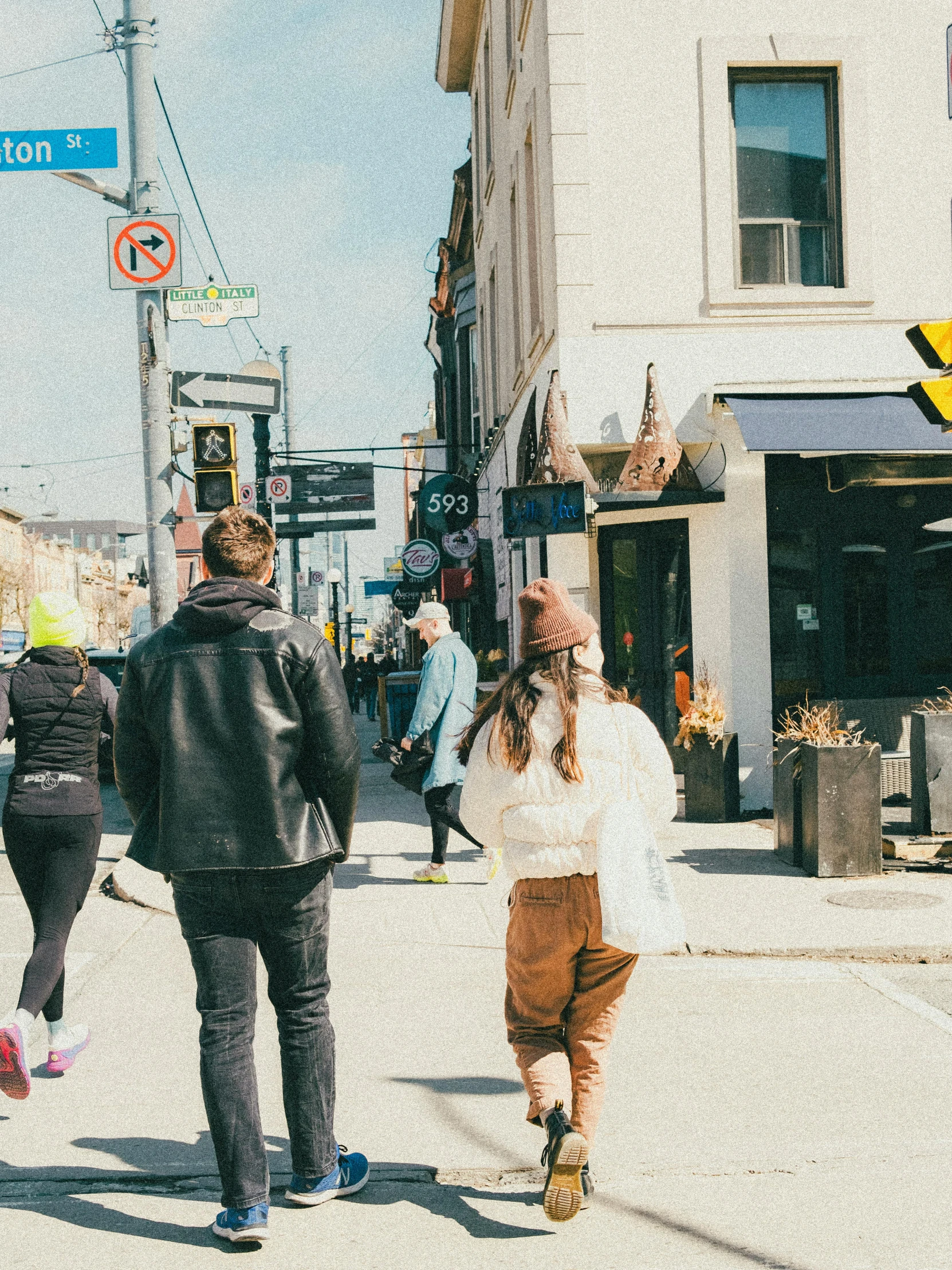 people walking down the street in an urban setting