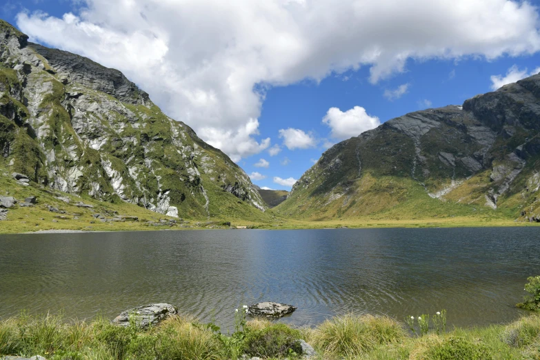 there is a body of water that can be seen near some mountains