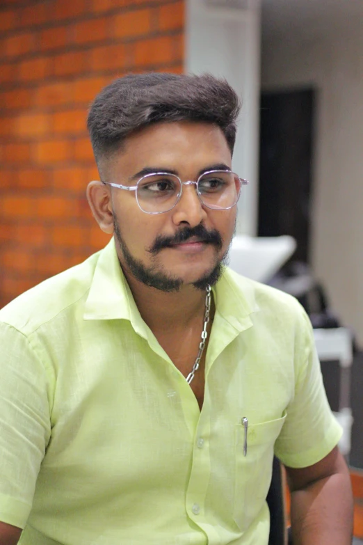 a man wearing eyeglasses and a lime shirt