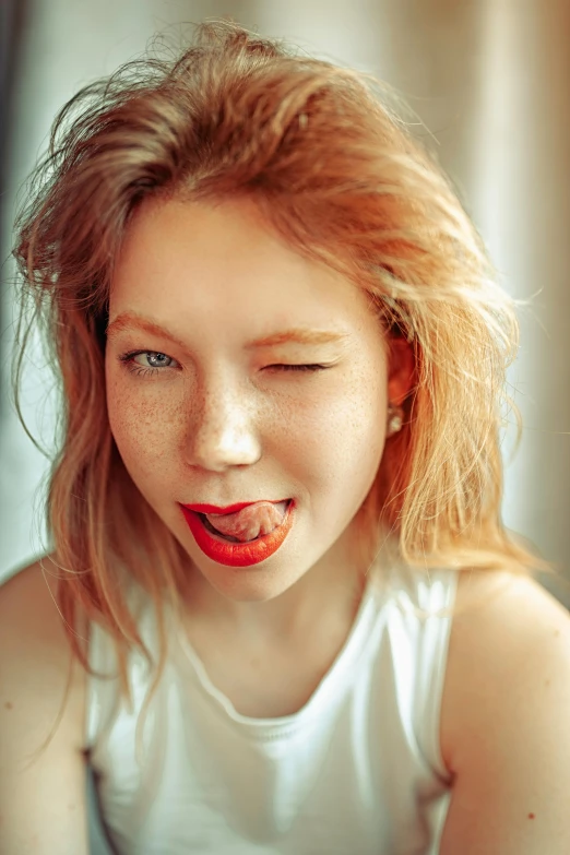 a small girl making a funny face with her hands