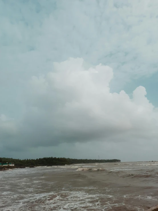 some people kite surfing on some very cloudy day