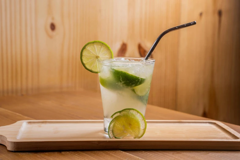 a glass of lemonade and lime with a straw