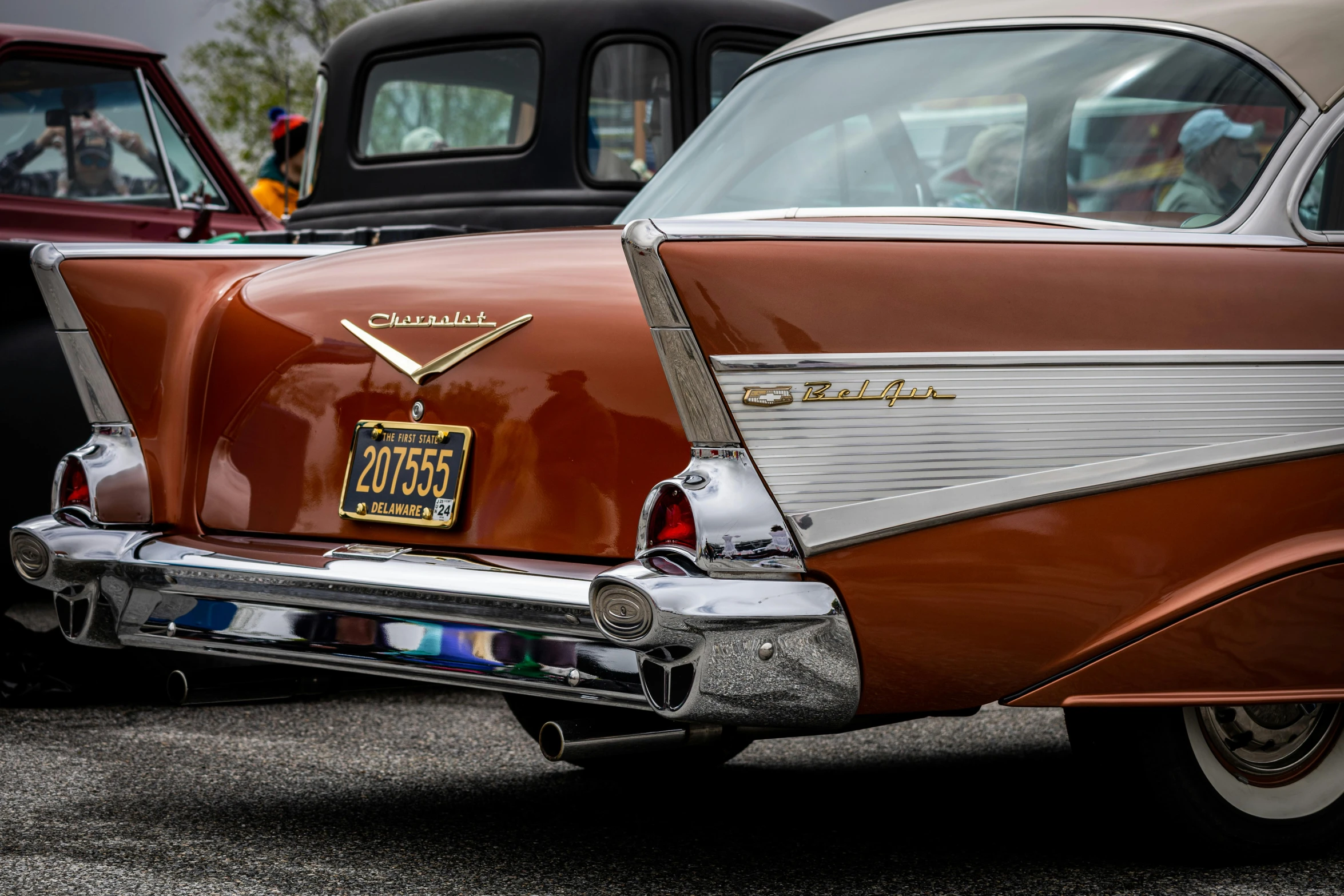 a classic car has a golden sticker on the trunk