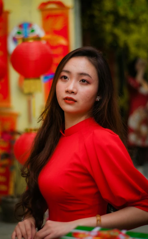 a woman in red dress posing for a po