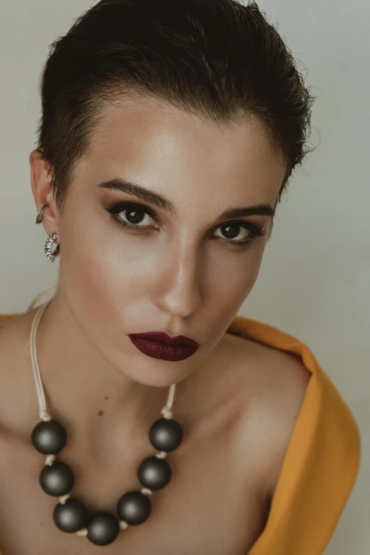 a woman with a pearl necklace and large earrings