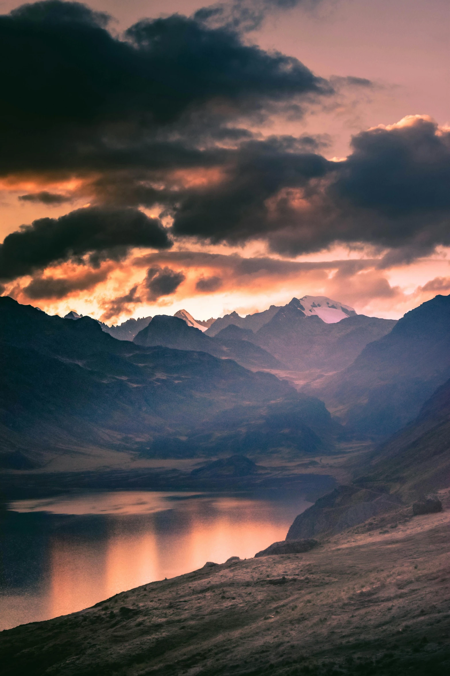 a picture of mountains with clouds in the sky