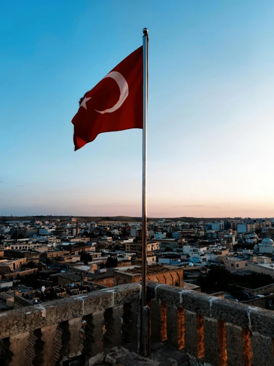 an old city with a turkish flag flying over it