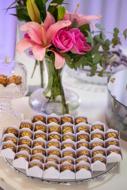 a close up of a plate of food near a vase with flowers