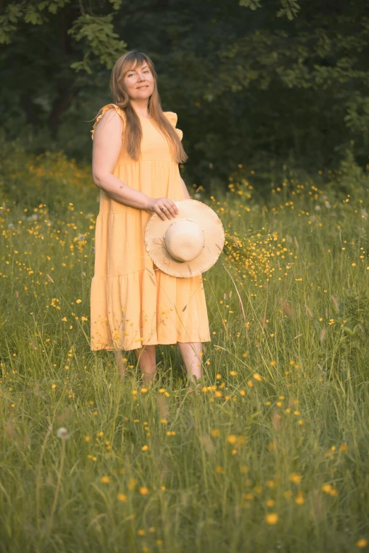 woman in a field wearing a yellow dress