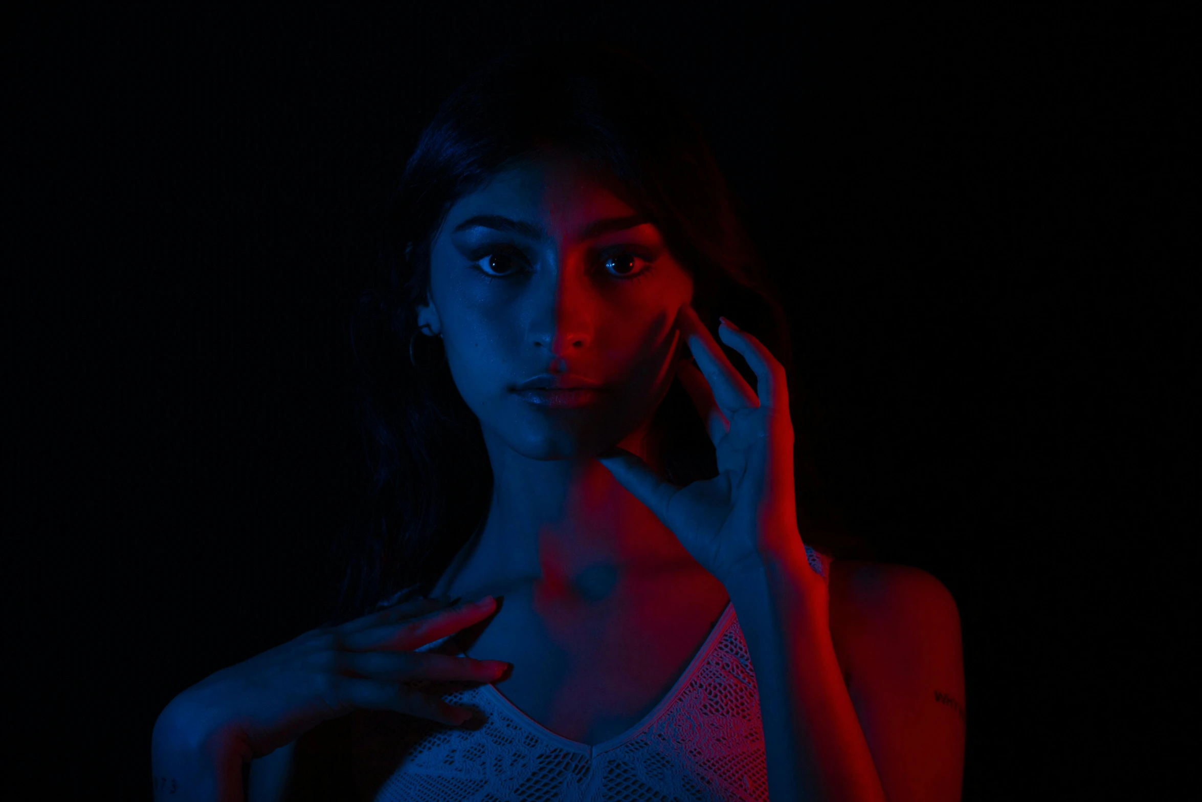 a woman is holding a cell phone to her ear and looking up at the camera