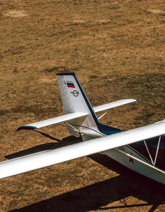 the airplane is sitting on the ground in the field