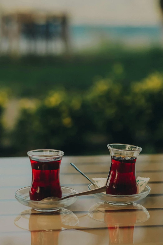 two cup filled with liquid sitting on top of a table