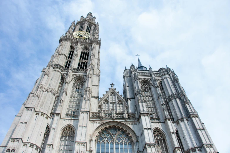 an old cathedral on a clear day, with a clock on the front