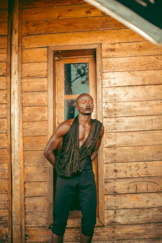 a man standing in front of a door while wearing pants