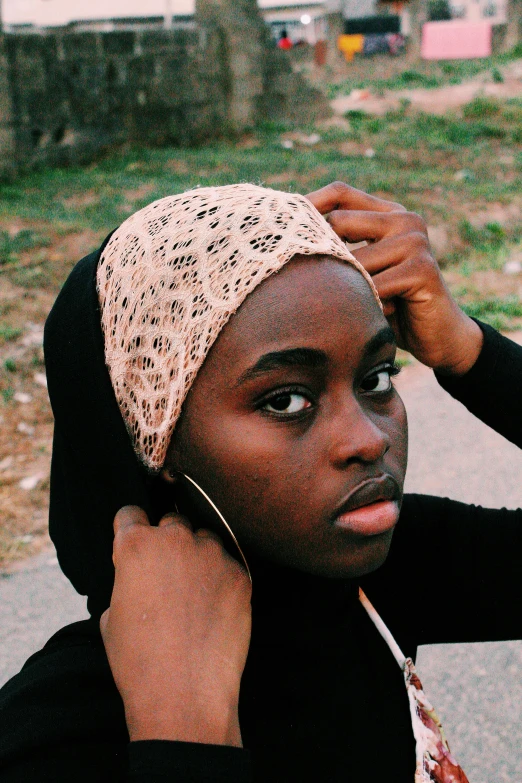 a woman in a turban smoking a cigarette